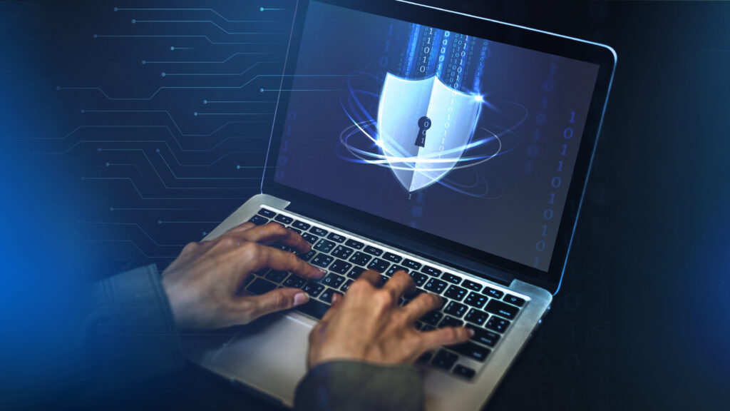 Person typing on a laptop with a digital security shield and binary code on the screen, symbolizing cybersecurity, data protection, and encryption software for protecting sensitive information on computers.