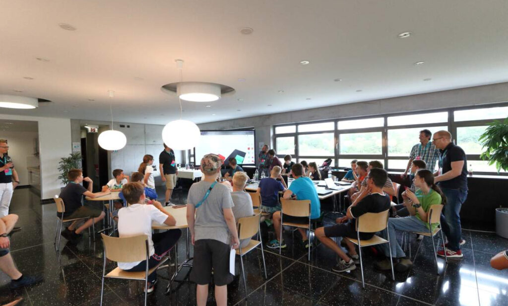 Group of students and instructors in a classroom setting, discussing data security and how to securely erase hard drives and centralize wiping tasks.