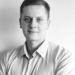 Black and white profile photo of Domantas Ciulde, CEO of iDenfy, wearing a white shirt, contributing a guest blog post for Jetico