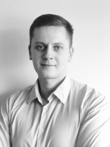 Black and white profile photo of Domantas Ciulde, CEO of iDenfy, wearing a white shirt, contributing a guest blog post for Jetico