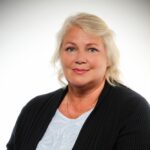 Professional portrait of Hannaleena Pojanluoma, CEO of Jetico and blog writer, wearing a black cardigan over a white blouse with a neutral background