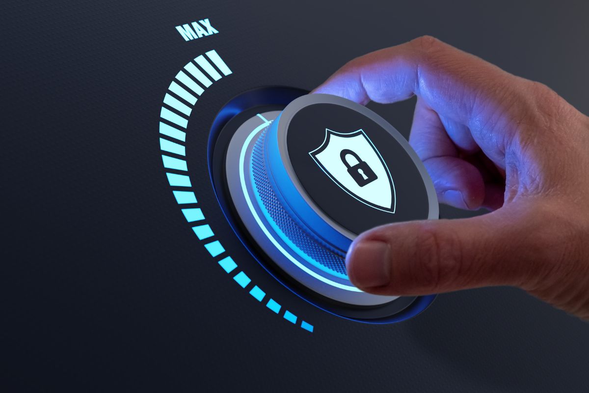 Hand turning a security knob with a shield and lock icon, adjusting to the highest encryption standards for advanced data protection.