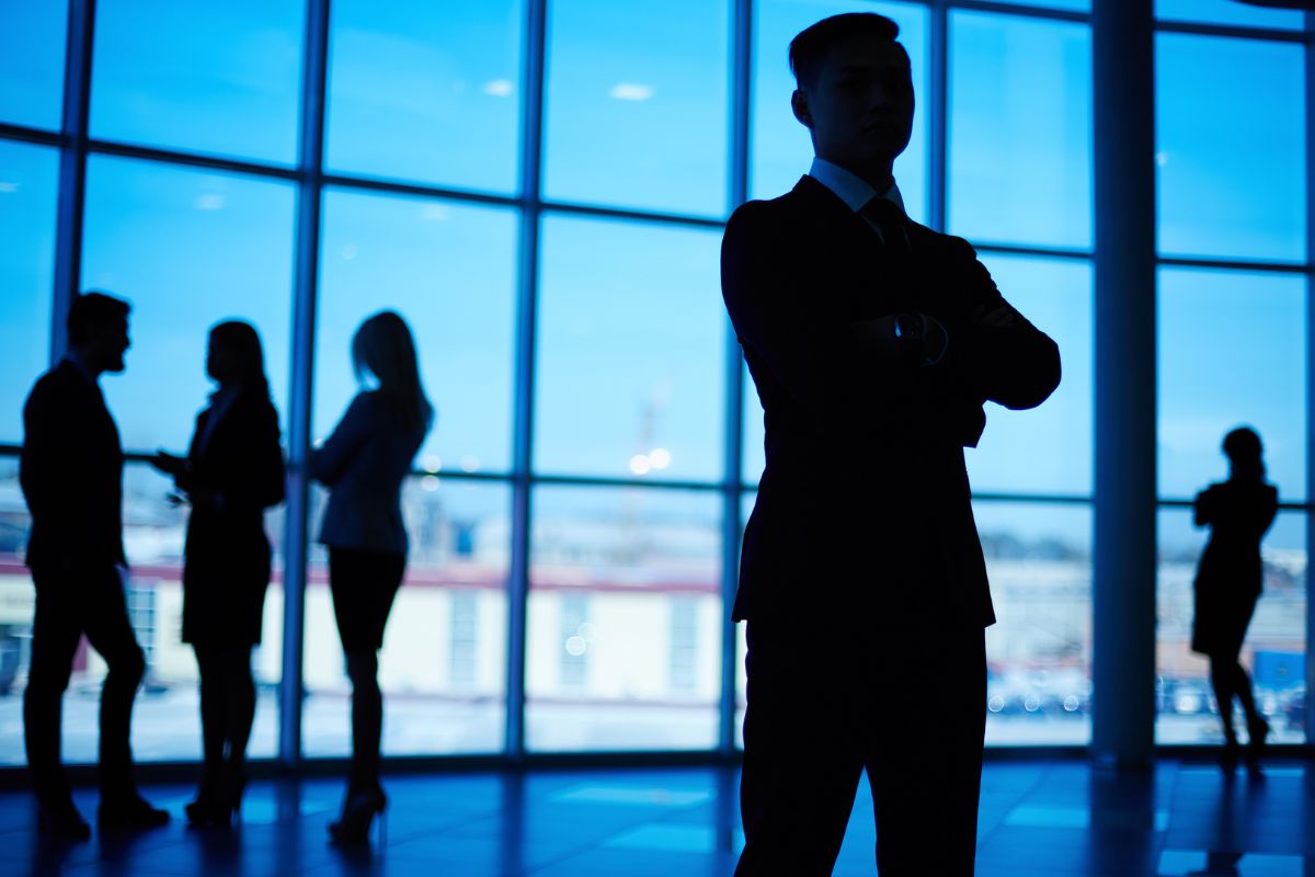 Silhouetted business professional standing confidently in front of a group, symbolizing leadership in transforming data protection solutions with advanced technology.