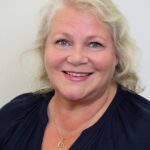 Professional portrait of Hannaleena Pojanluoma, CEO of Jetico and blog writer, wearing a blue shirt with a neutral background
