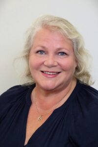 Professional portrait of Hannaleena Pojanluoma, CEO of Jetico and blog writer, wearing a blue shirt with a neutral background